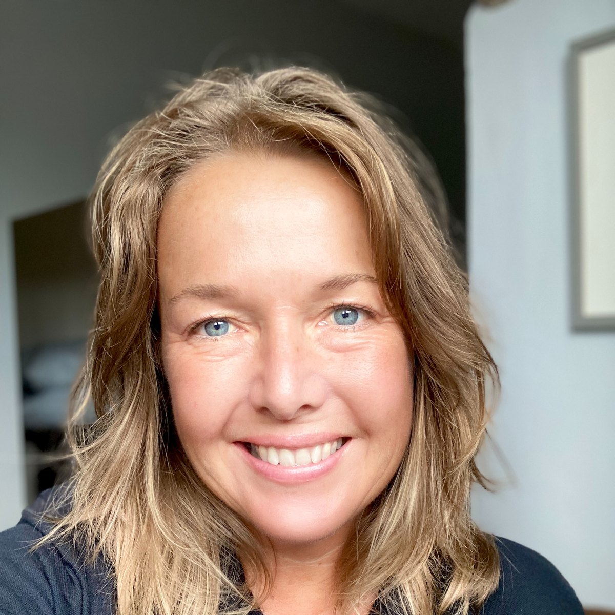 Lisa Kossuth, smiling, in a navy FHT polo shirt
